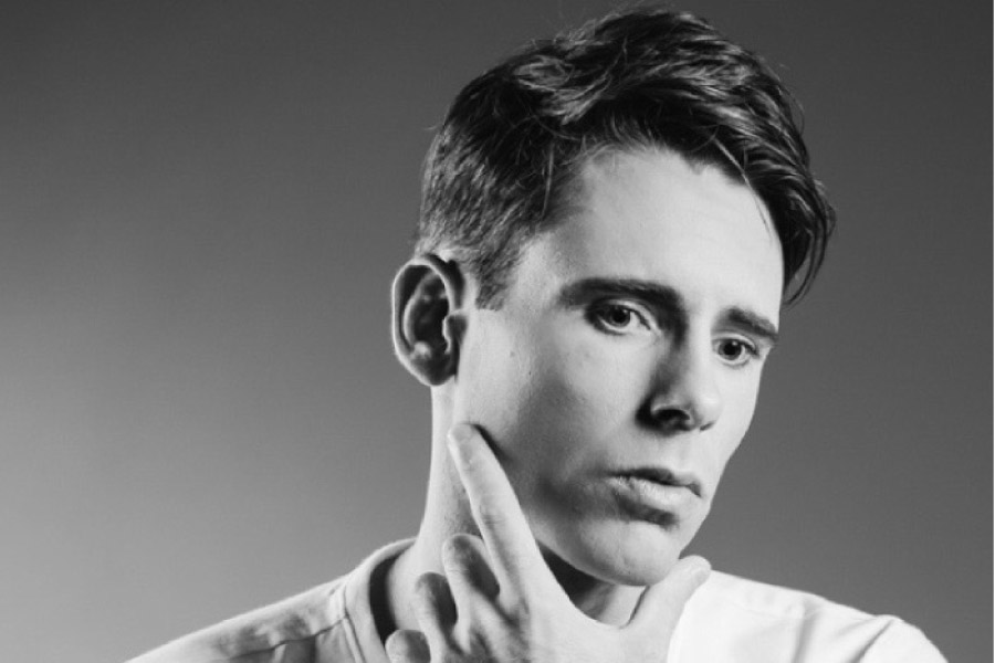 man holds his neck to check his thyroid